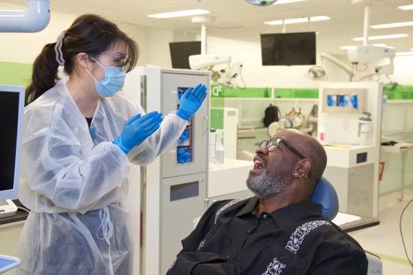 Smiling man in clinic talking to dentist