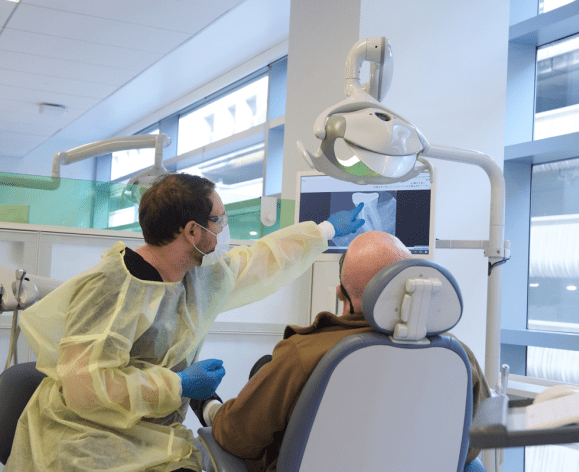 patient and dental student in clinic